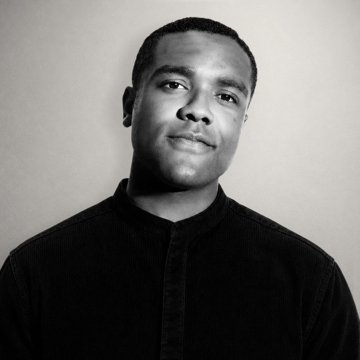 merchant in a black shirt, photographed in warm monochrome